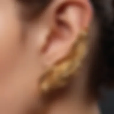 Close-up of a gold ear cuff being worn, highlighting its elegance